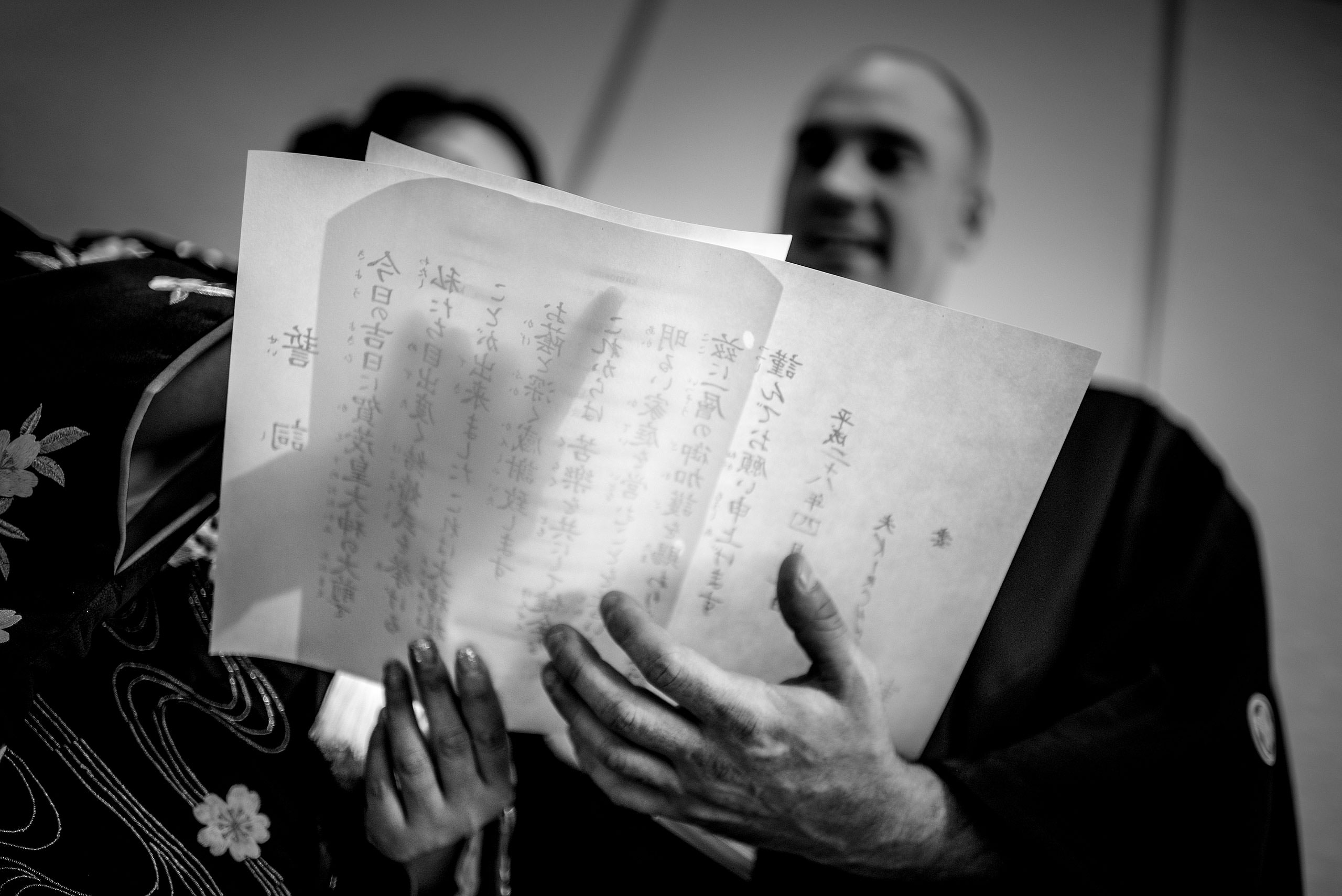 a Japanese bride and groom reading a document by Japan Destination Wedding Photographer Sean LeBlanc