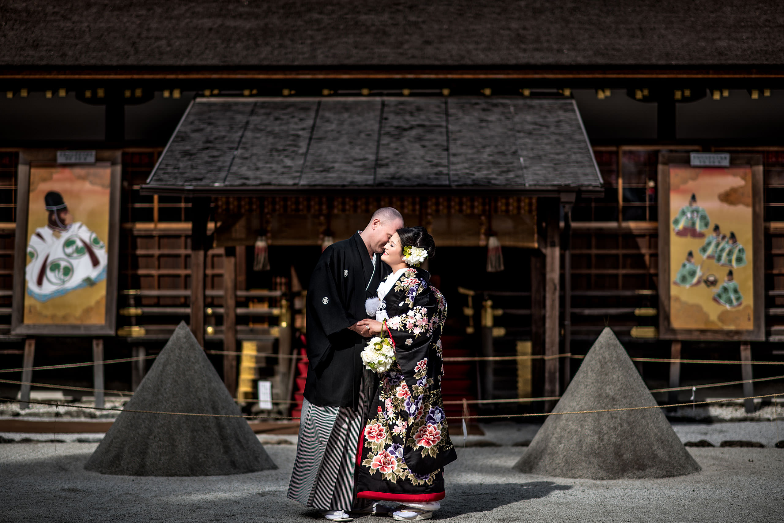 Japanese bride and groom embracing in front of a Japanese temple by Japan Destination Wedding Photographer Sean LeBlanc