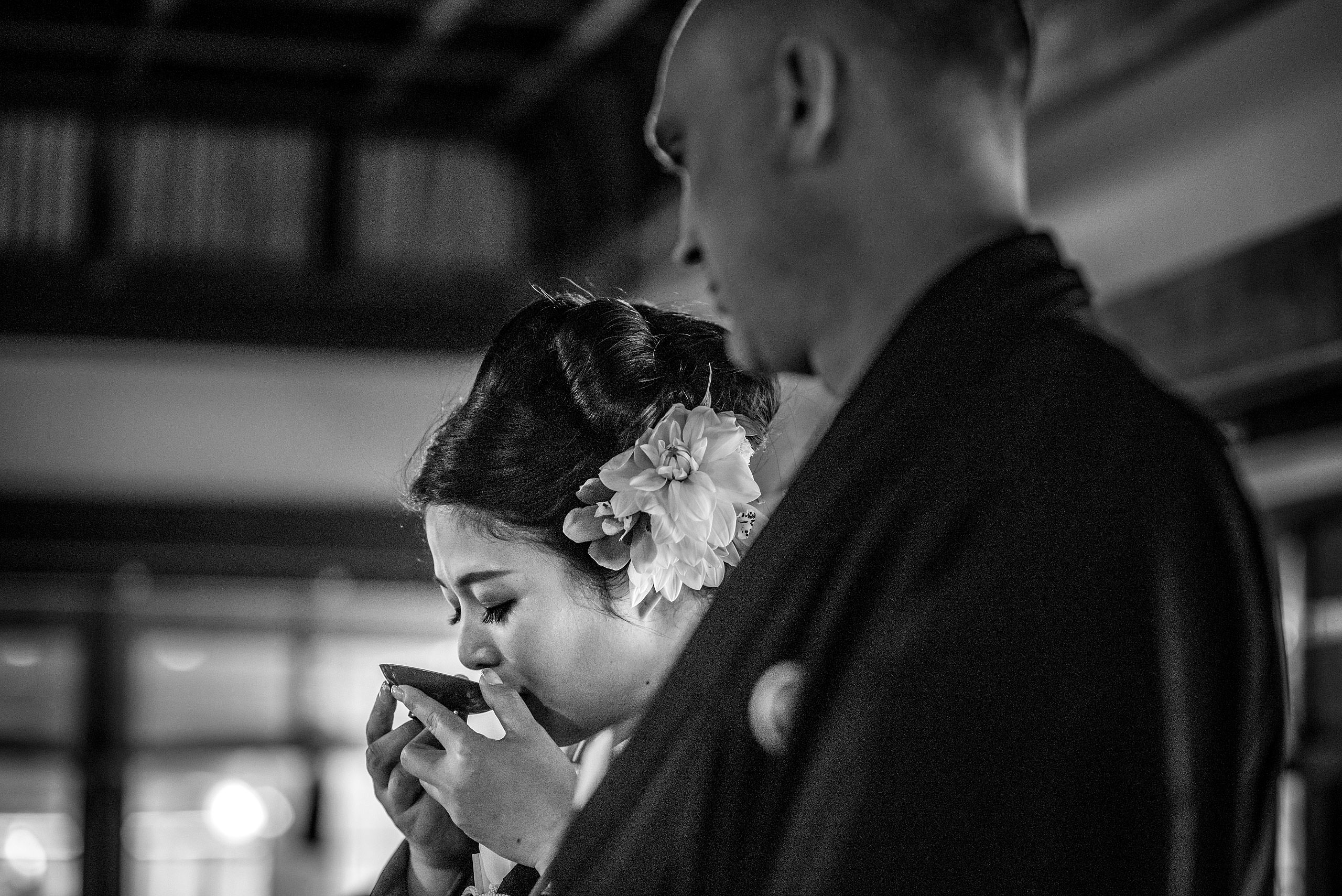 a Japanese women drinking from a cup by Japan Destination Wedding Photographer Sean LeBlanc