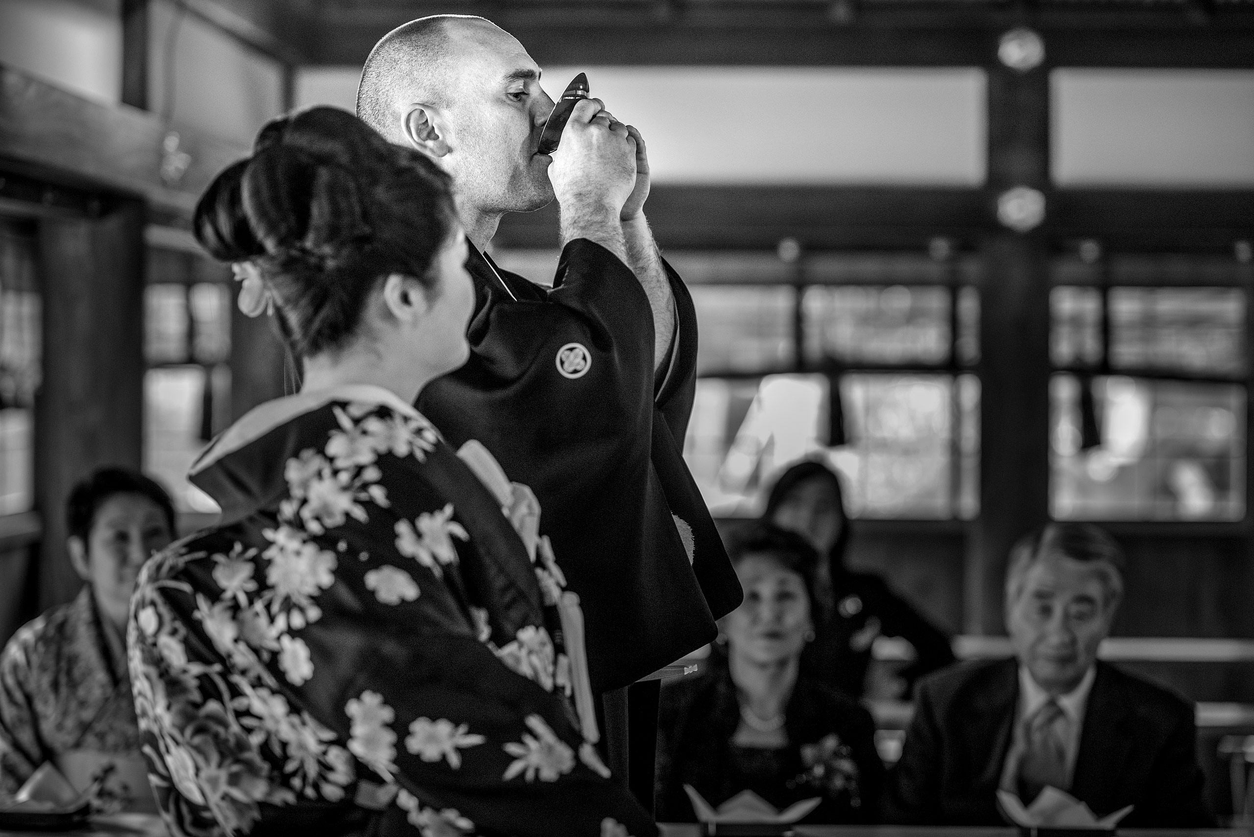 a groom drinking from a cup by Japan Destination Wedding Photographer Sean LeBlanc