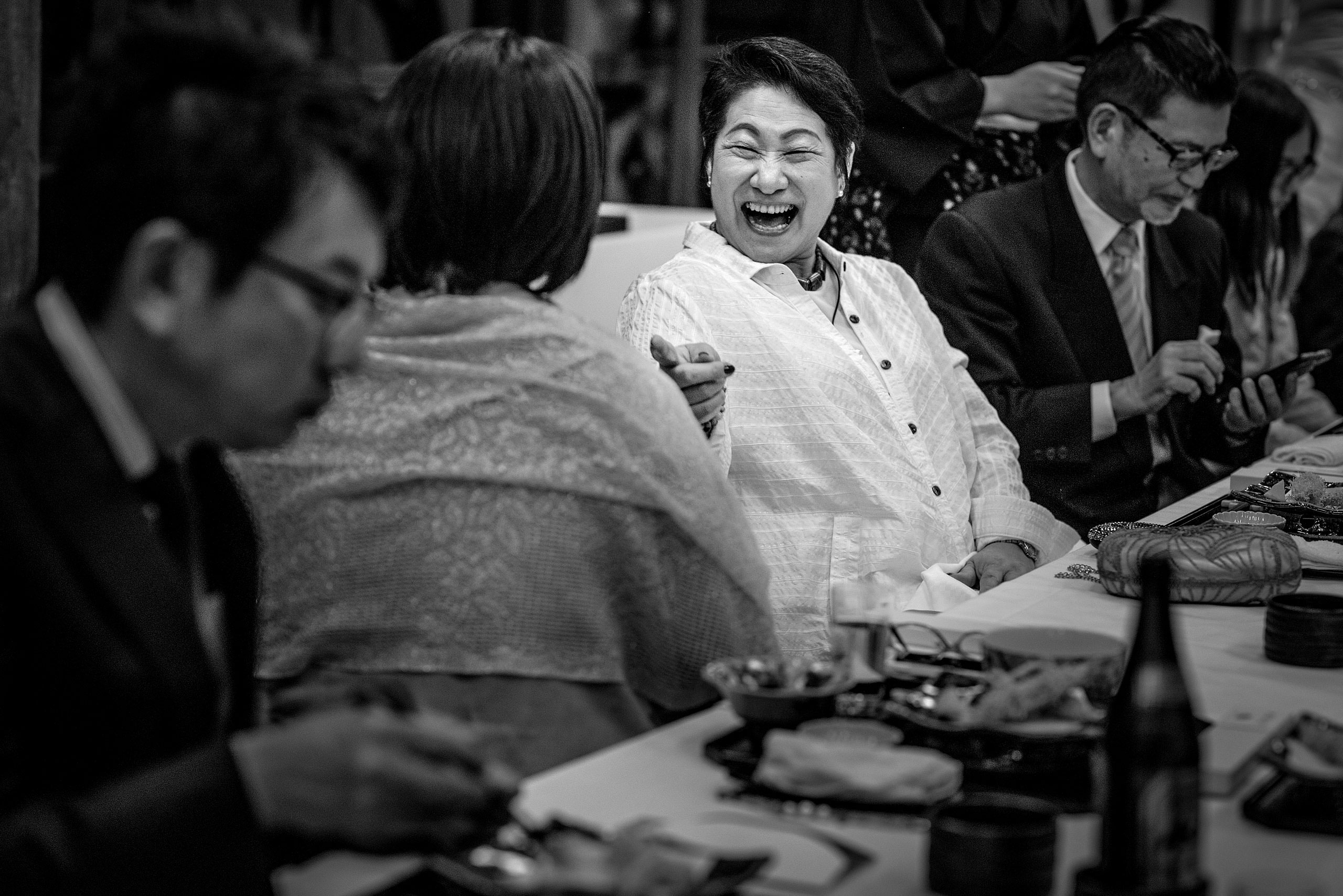 a wedding guest laughing by Japan Destination Wedding Photographer Sean LeBlanc