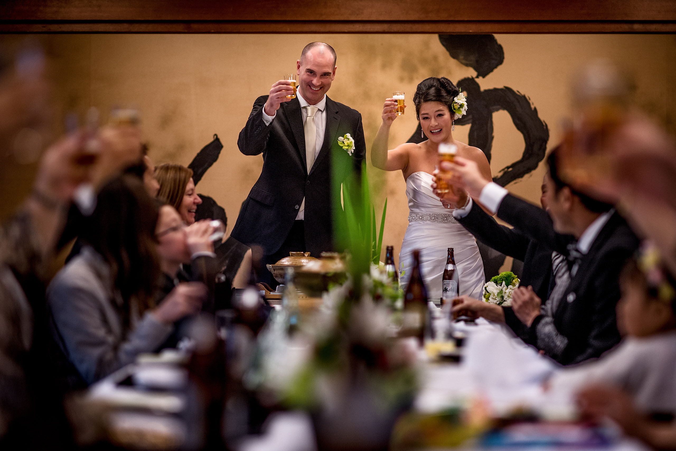 a bride and groom raising their glasses to their guests by Japan Destination Wedding Photographer Sean LeBlanc