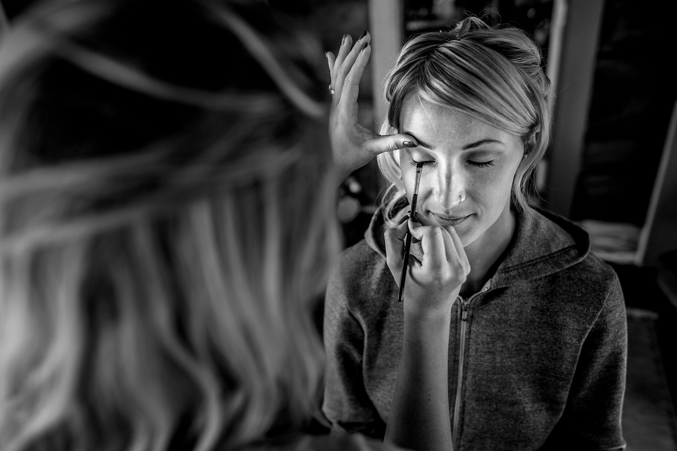 bride getting makeup applied on her wedding day at Cochrane Country Wedding by Sean LeBlanc