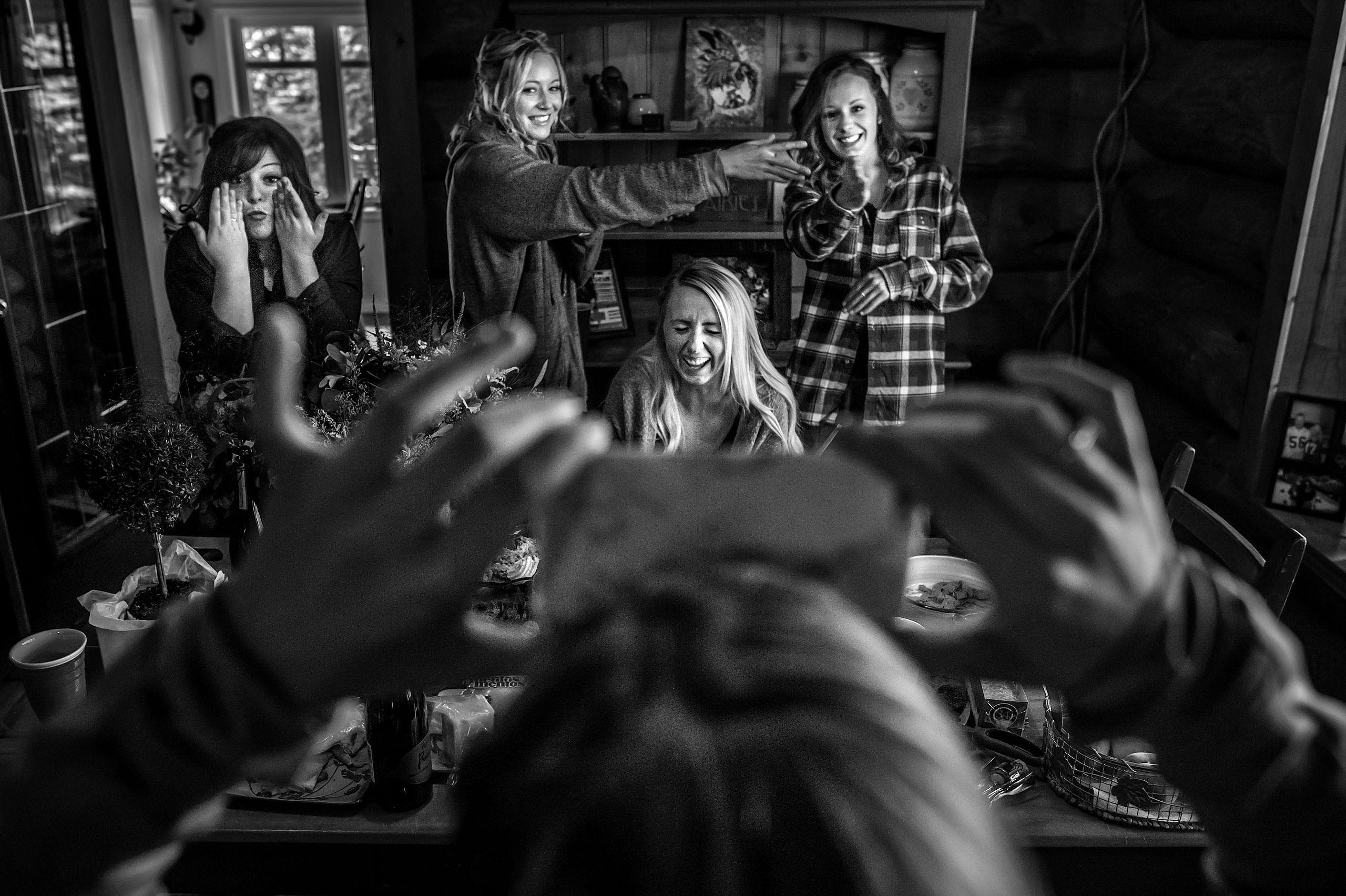 bridesmaids laughing at a game while they get ready for the wedding day at Cochrane Country Wedding by Sean LeBlanc