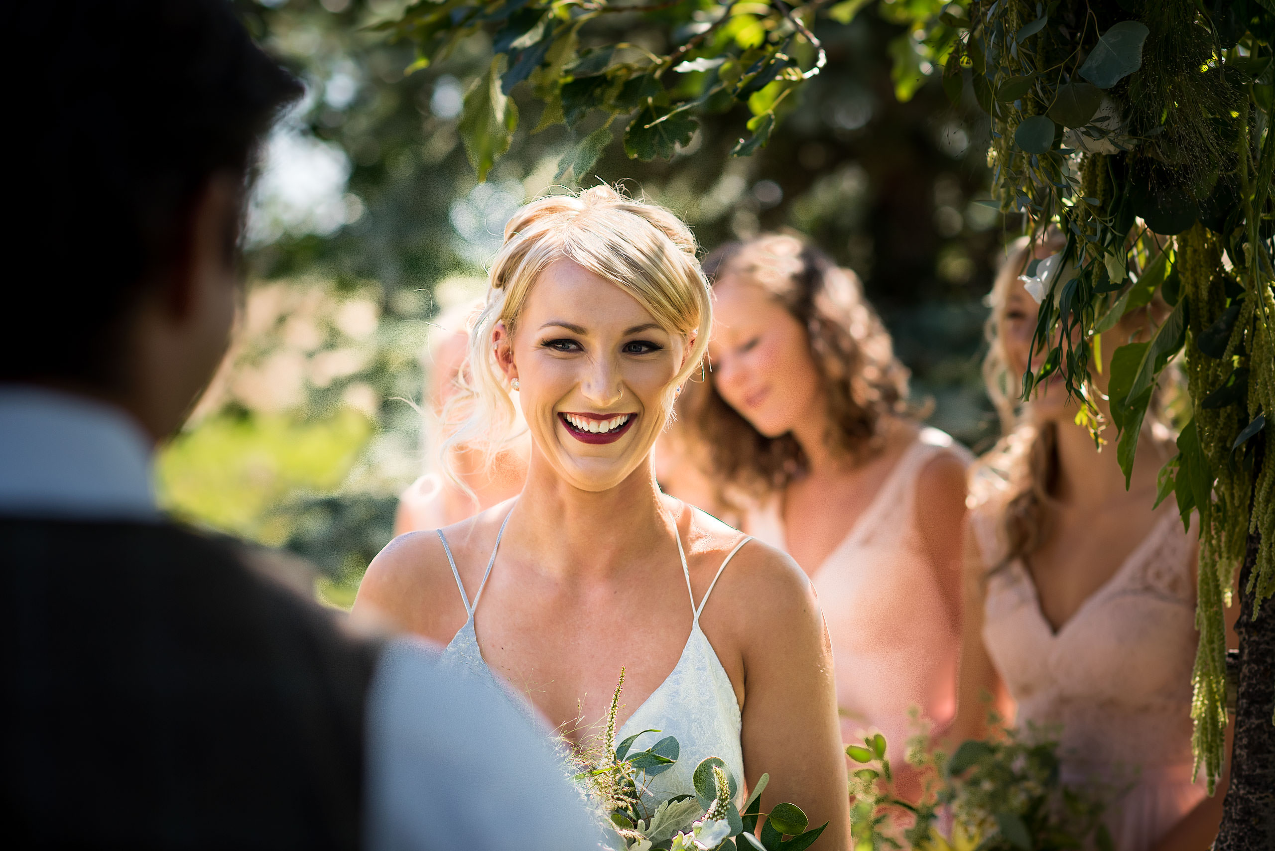 bride smiling at her groom during their ceremony at Cochrane Country Wedding by Sean LeBlanc
