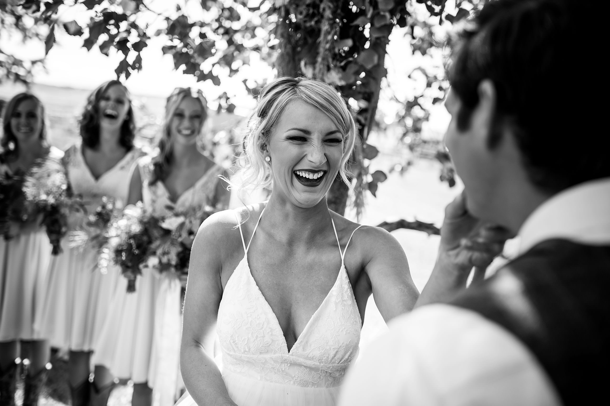 a bride wiping lipstick off of her groom at Cochrane Country Wedding by Sean LeBlanc