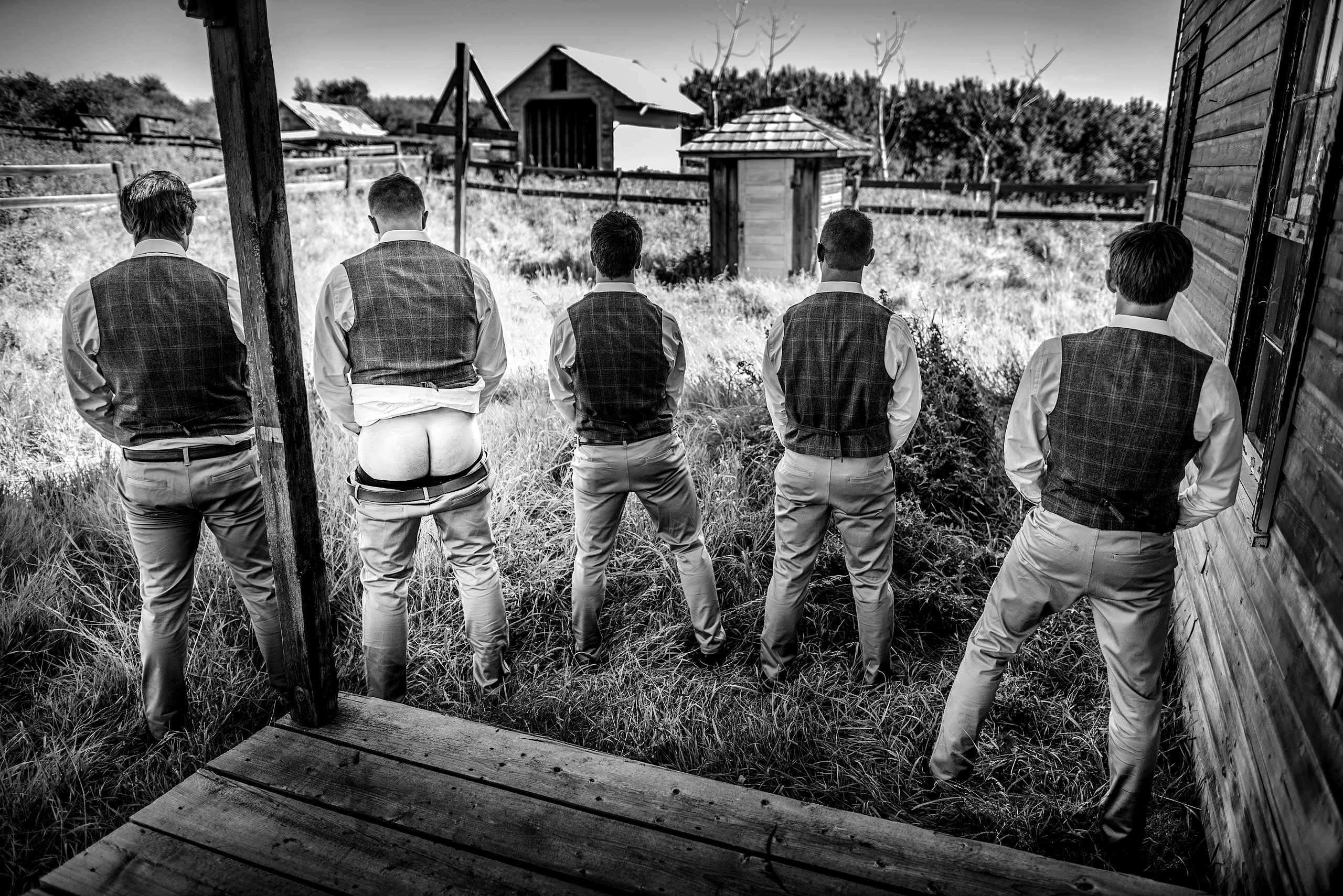 groomsmen outside infant of a house at Cochrane Country Wedding by Sean LeBlanc