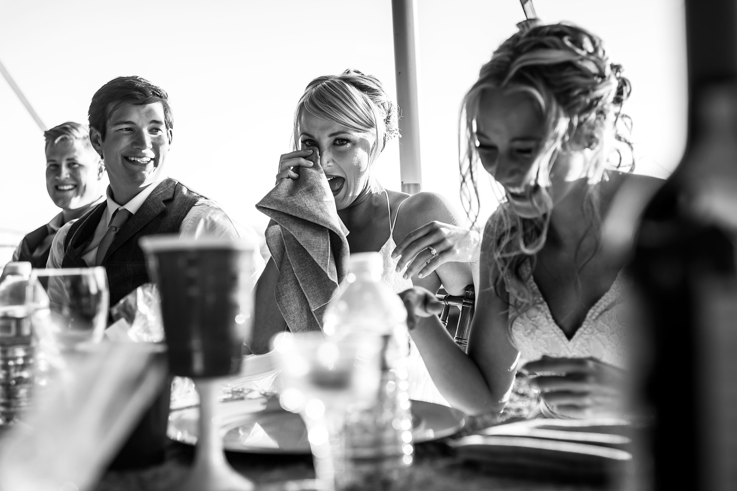 bride whipping a tear of laughter from her eye at Cochrane Country Wedding by Sean LeBlanc