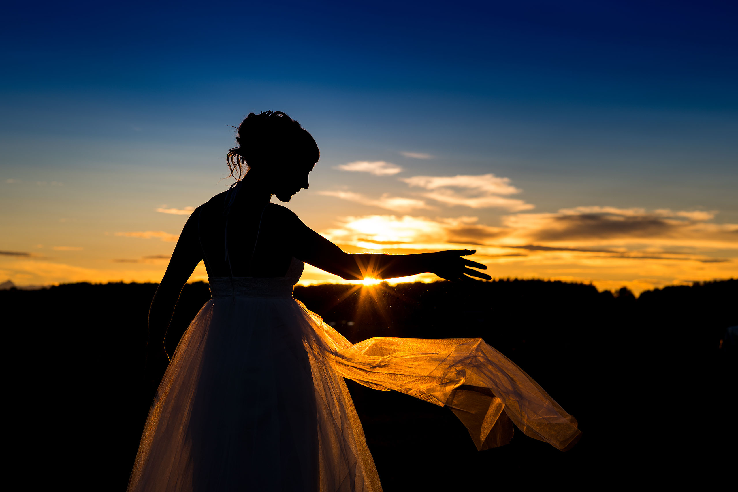 a bride throwing her dress at dusk at Cochrane Country Wedding by Sean LeBlanc