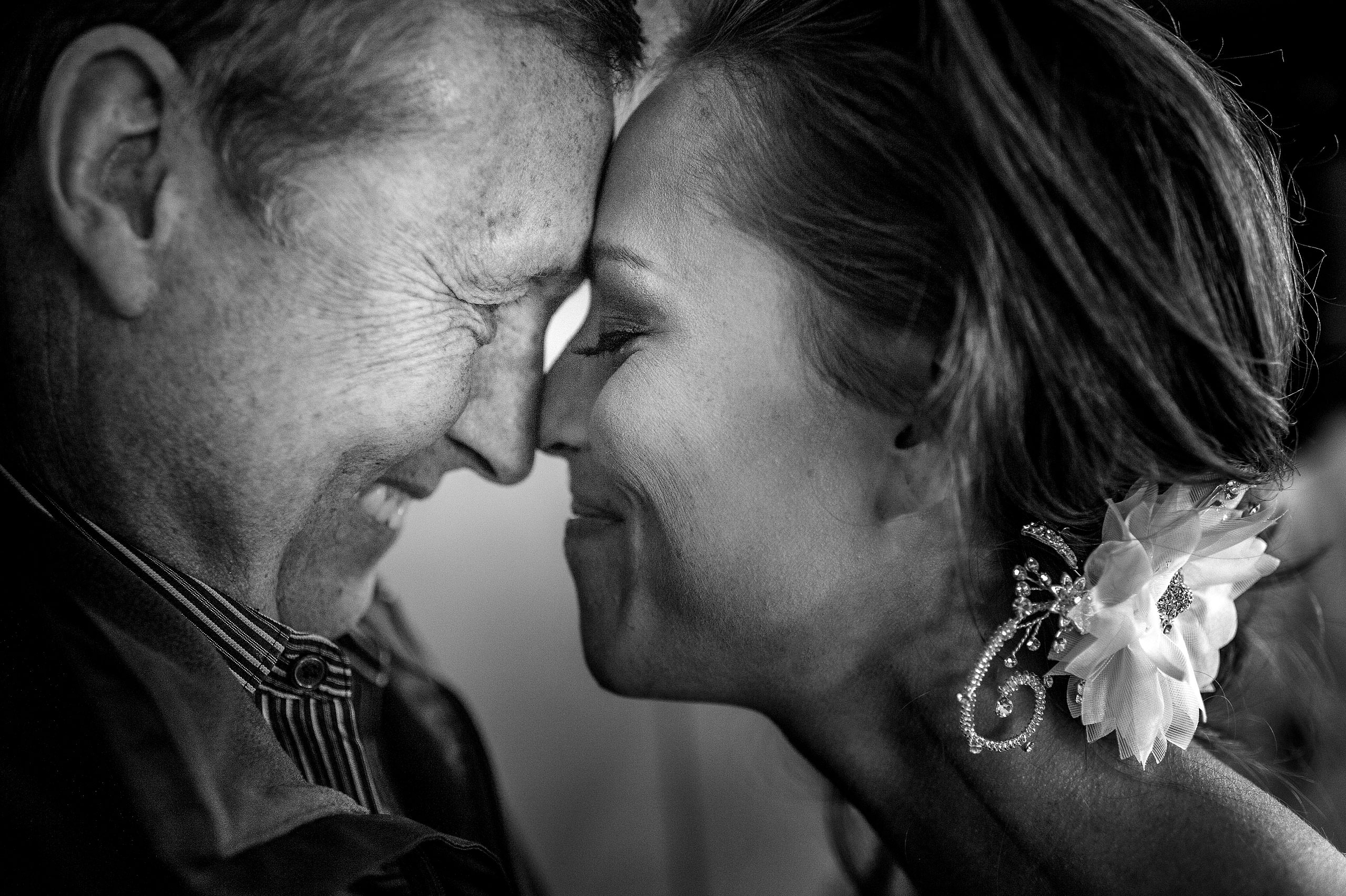 a bride touching foreheads with her dad at Priddis Azuridge Wedding by sean leblanc