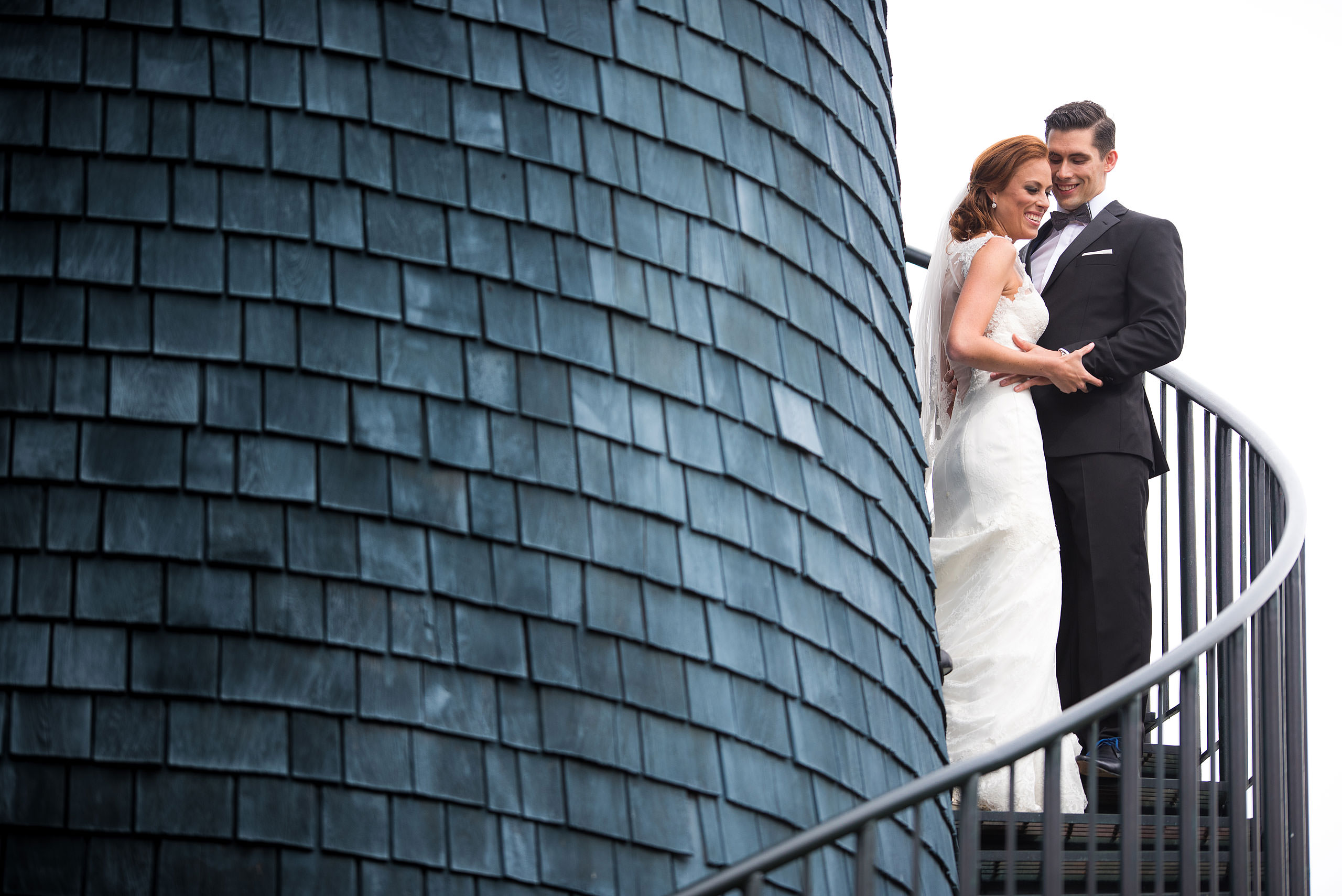 a bride and groom embracing on some stairs at Priddis Azuridge Wedding by sean leblanc