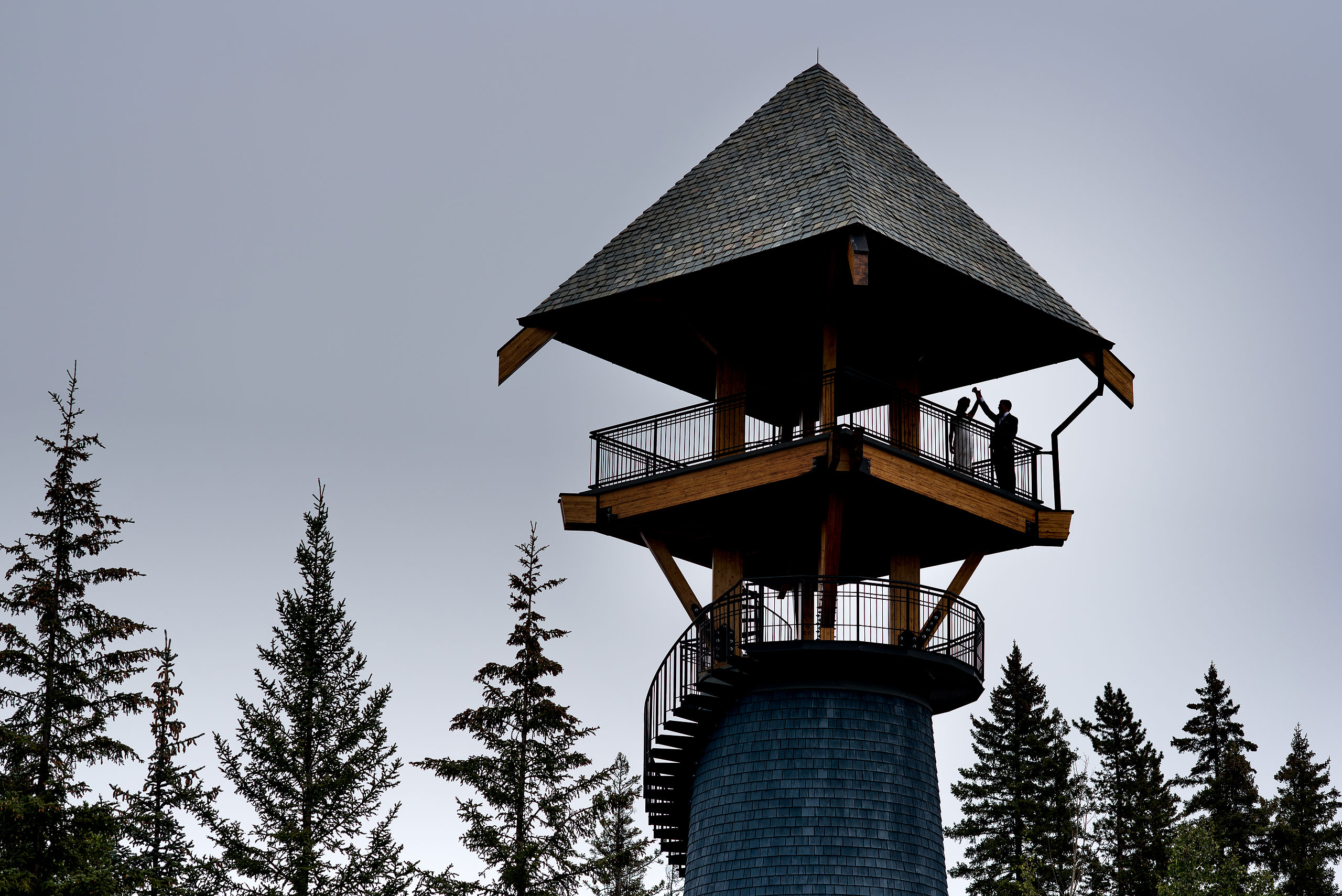 a bride and groom dancing on the top of a tower at Priddis Azuridge Wedding by sean leblanc