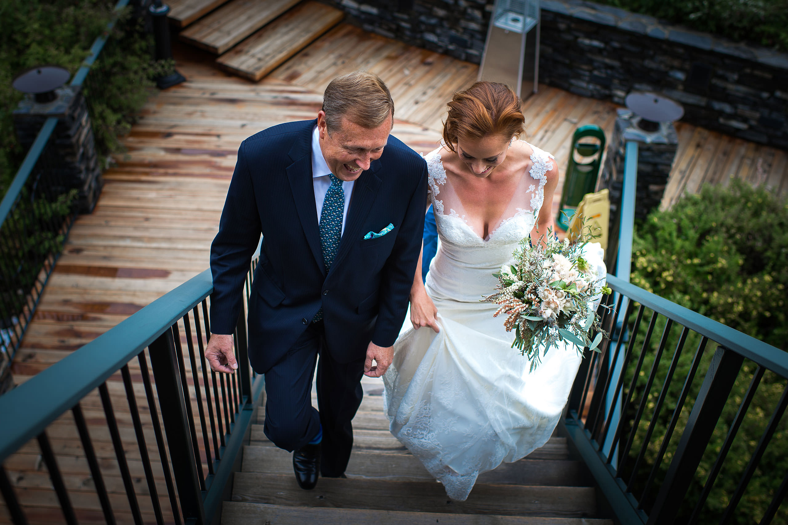 bride walking with dad up the stairs at Priddis Azuridge Wedding by sean leblanc