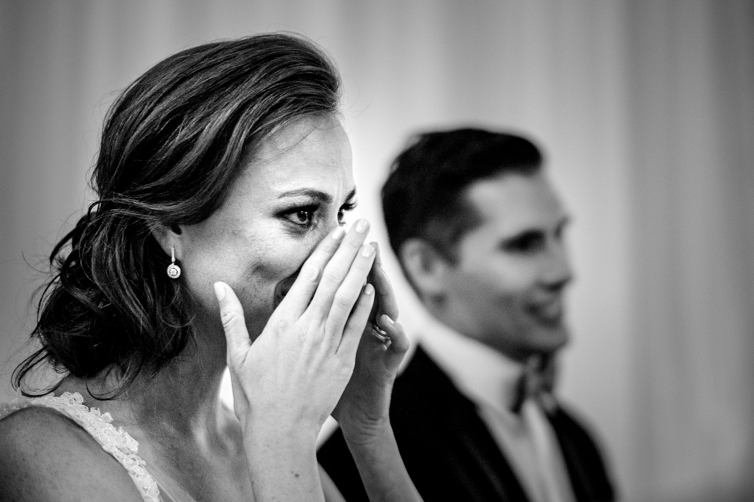 a bride wiping tears from her eyes at Priddis Azuridge Wedding by sean leblanc