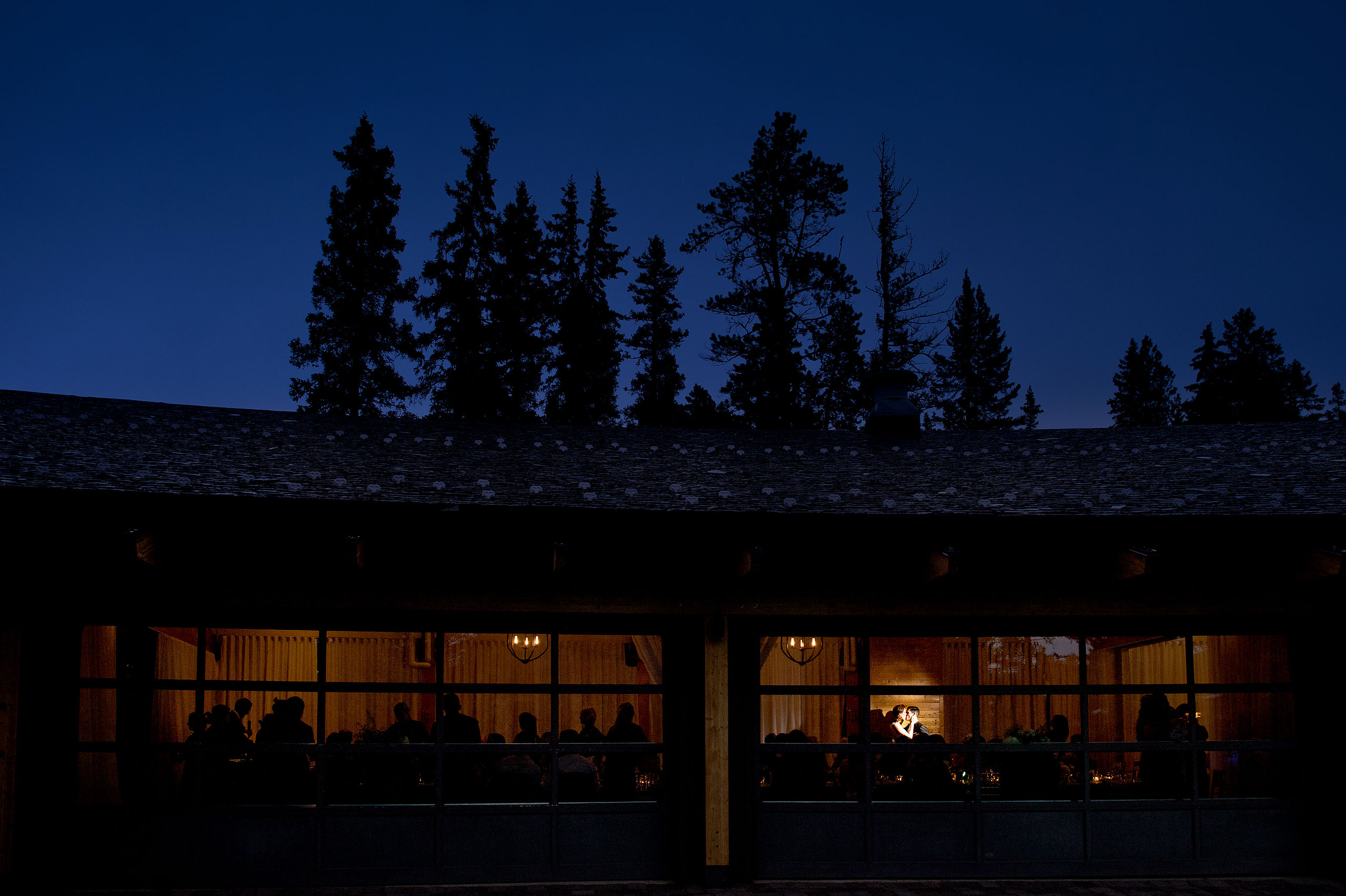 a bride and groom kissing at a reception at Priddis Azuridge Wedding by sean leblanc