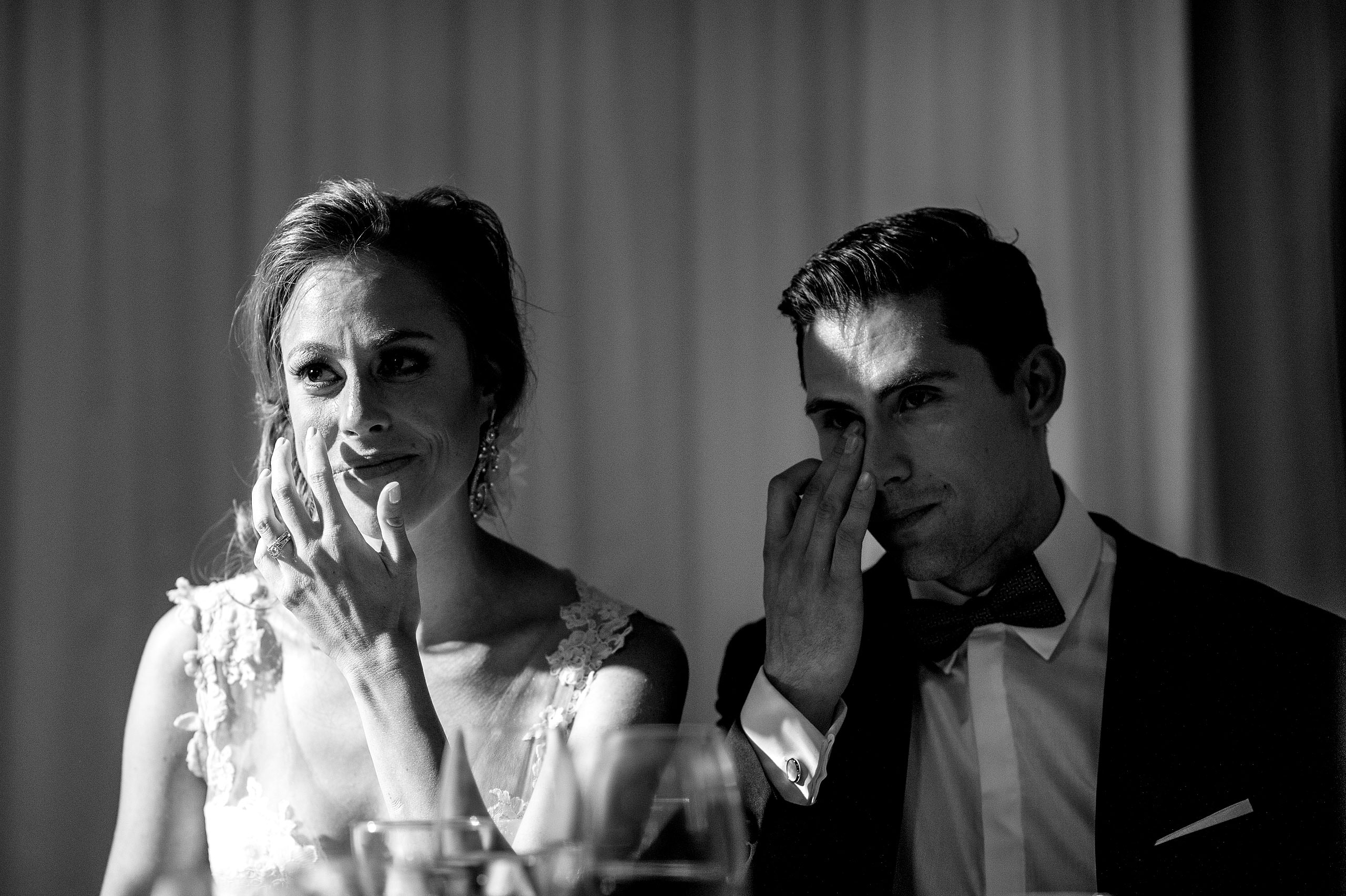 a bride and groom wiping tears from their eyes at Priddis Azuridge Wedding by sean leblanc