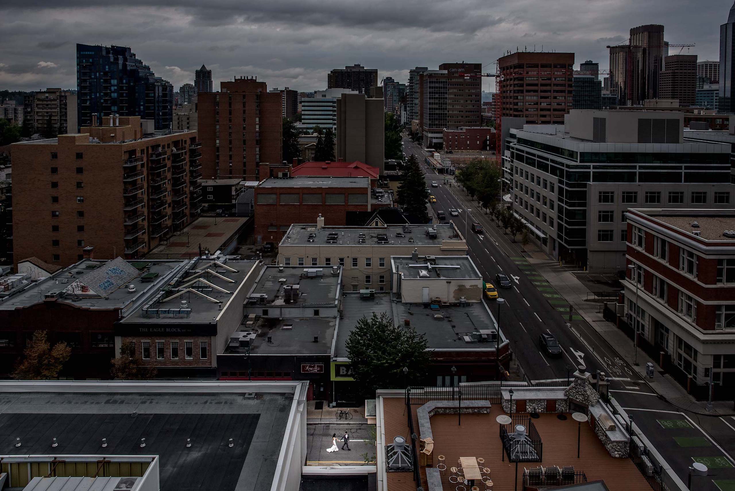 bride and groom walking in downtown by top calgary wedding photographer sean leblanc