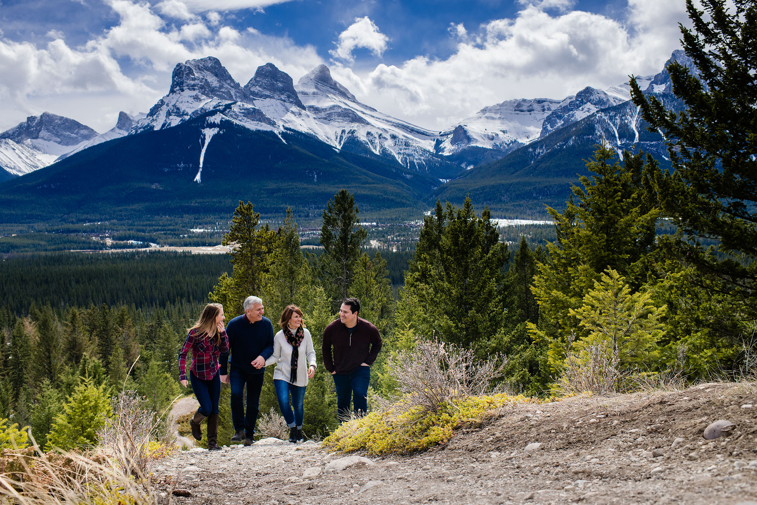 a family of four walking up a mountain together by Canmore Family Photographer Sean LeBlanc