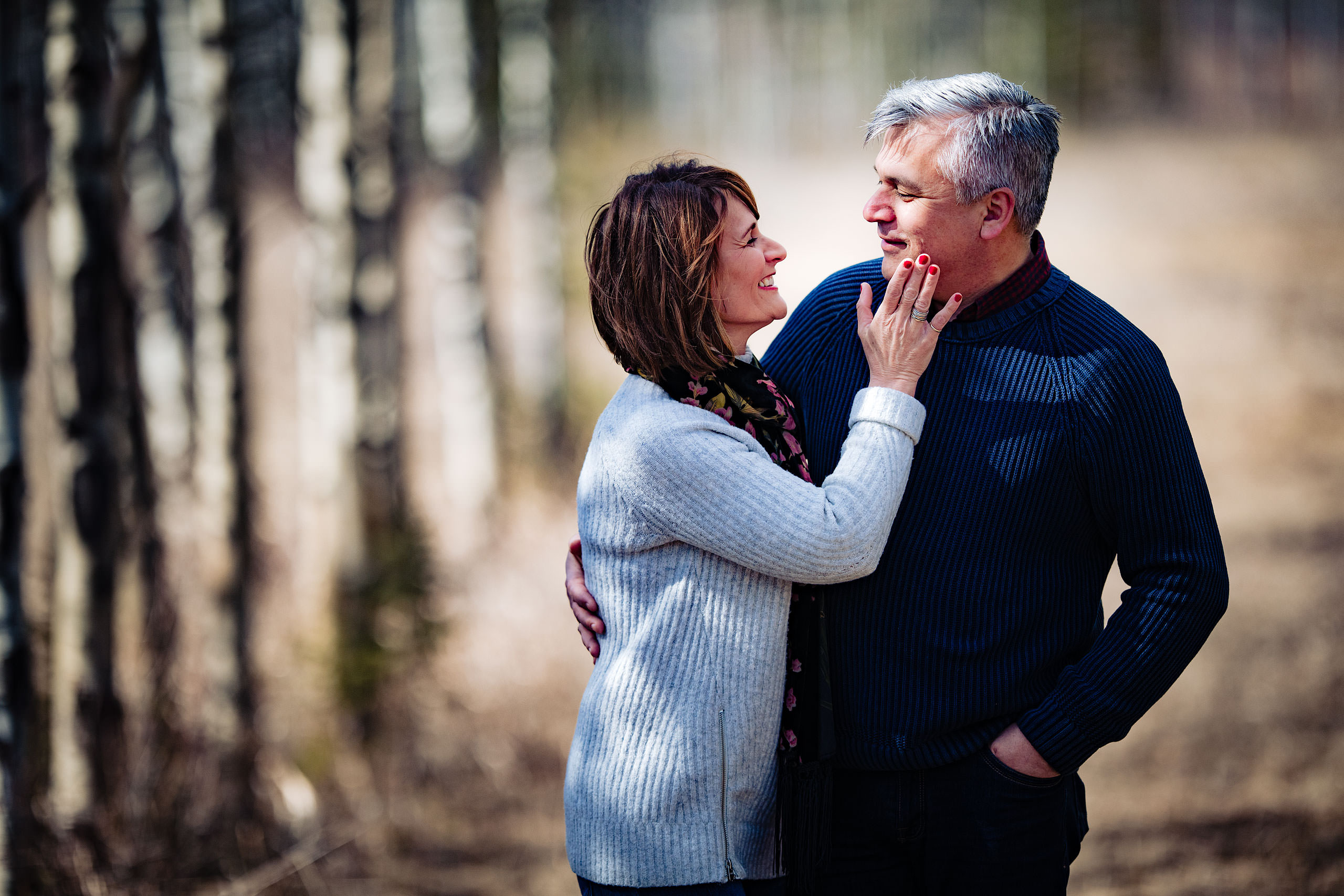 a wife holding the cheek of her husband by Canmore Family Photographer Sean LeBlanc