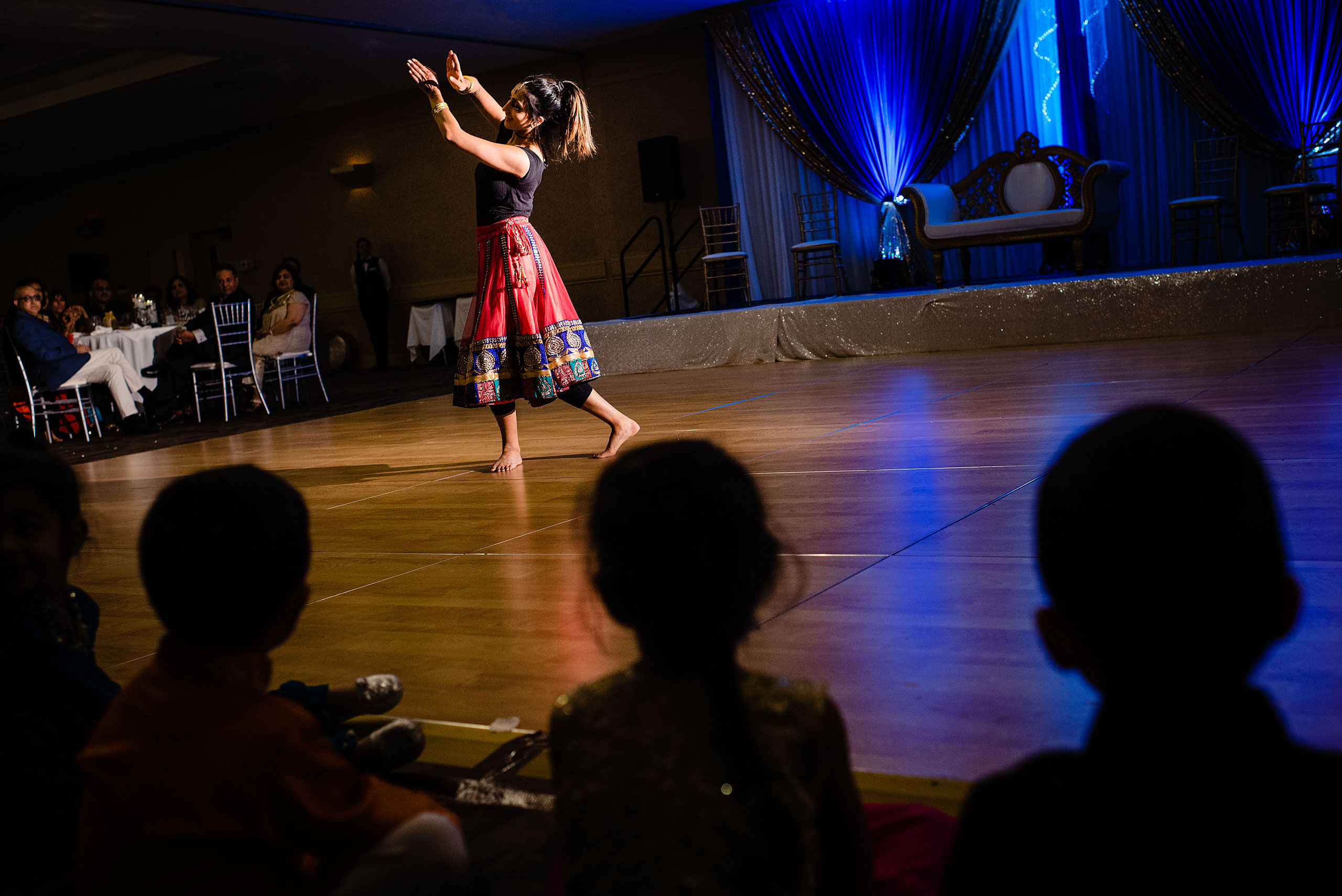 an indian dancer performing at a wedding by Calgary Banff Wedding Photographer Sean LeBlanc