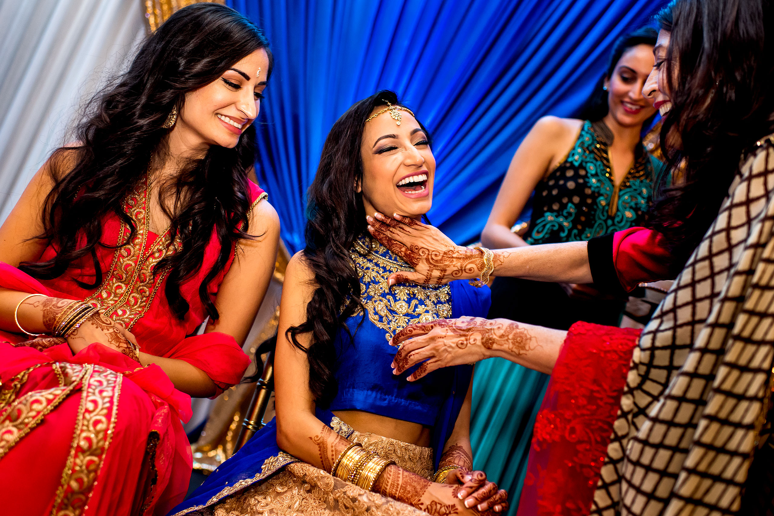 an indian bride laughing by Calgary Banff Wedding Photographer Sean LeBlanc