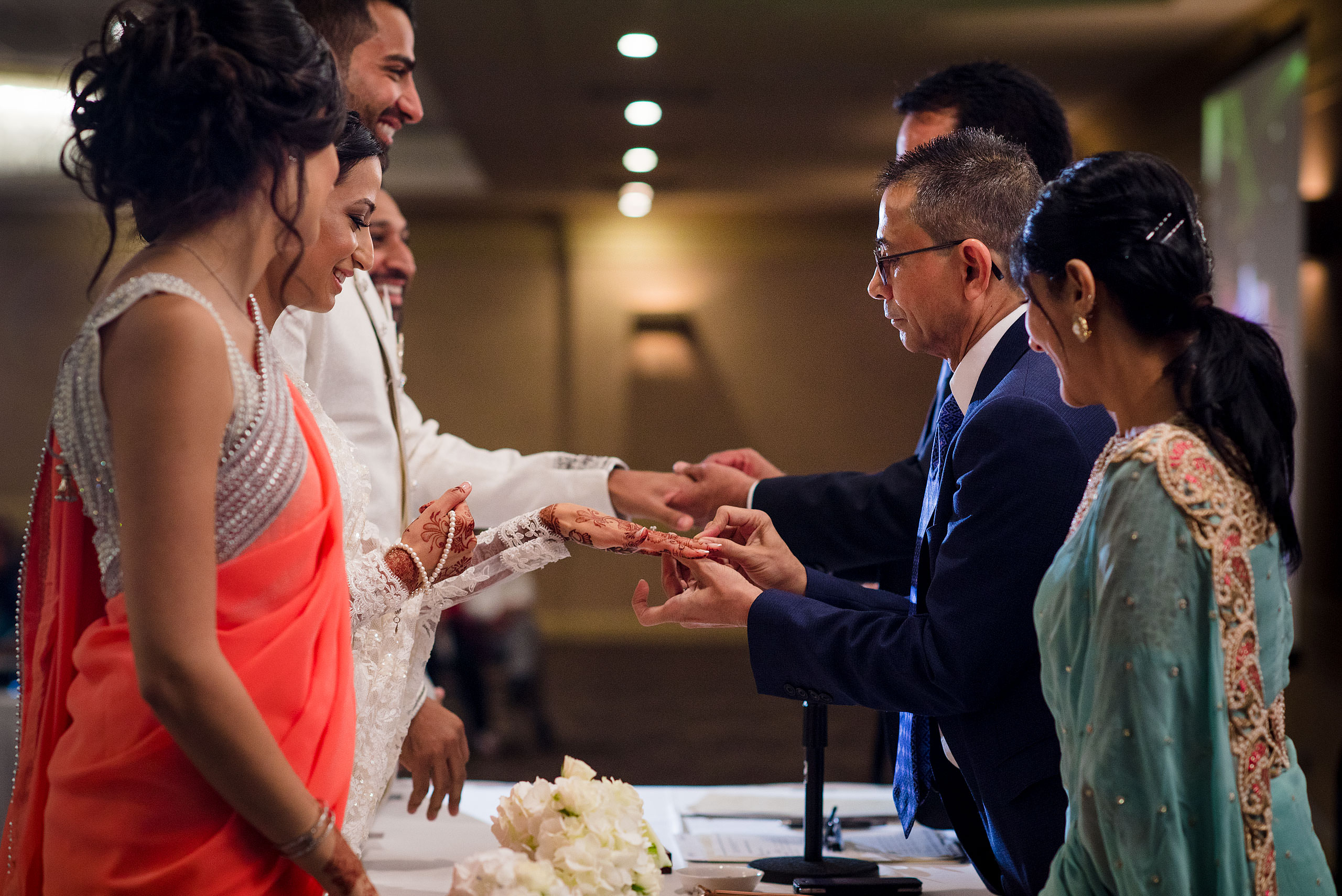 a group of people exchanging rings by Calgary Banff Wedding Photographer Sean LeBlanc