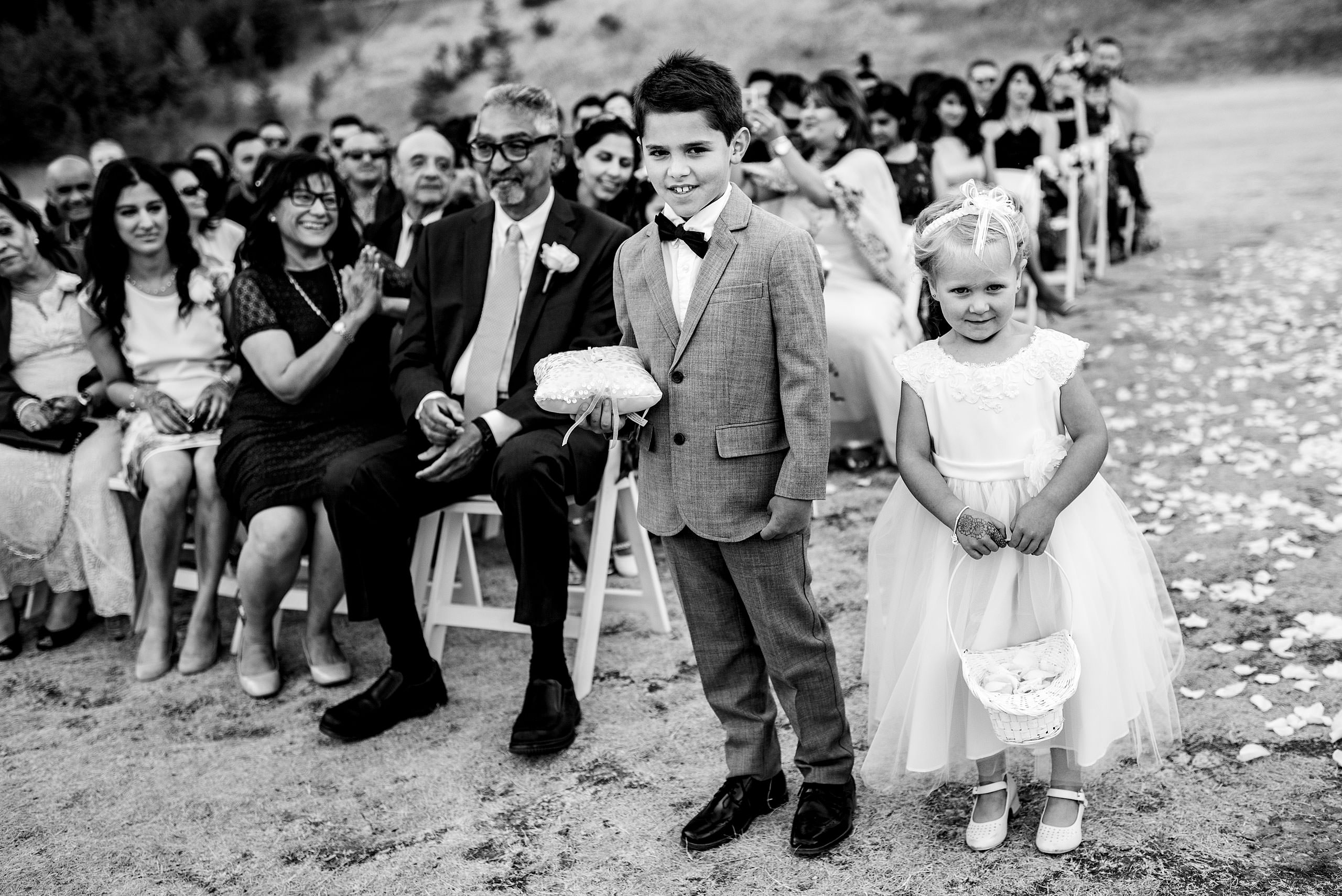 two young children standing at the from of a wedding ceremony by Calgary Banff Wedding Photographer Sean LeBlanc