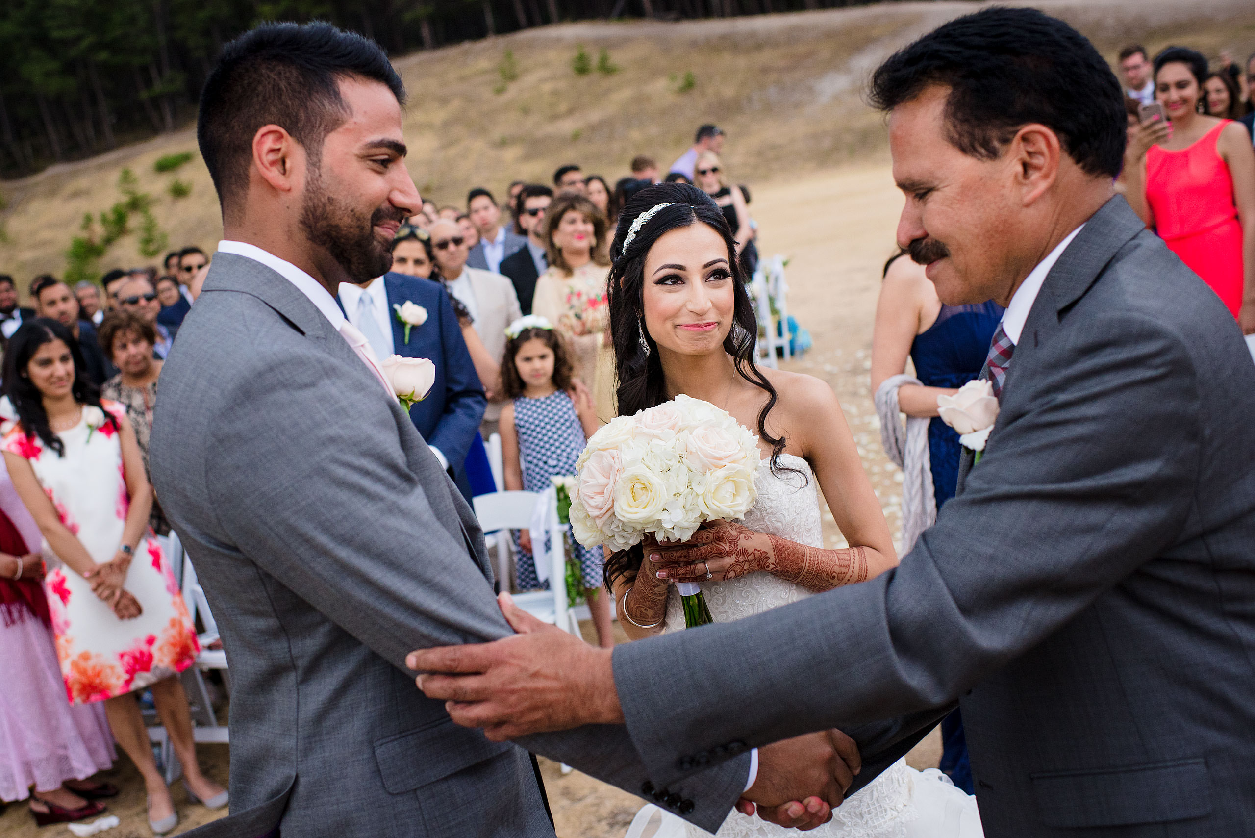 a bride's dad shaking the hand of a groom by Calgary Banff Wedding Photographer Sean LeBlanc