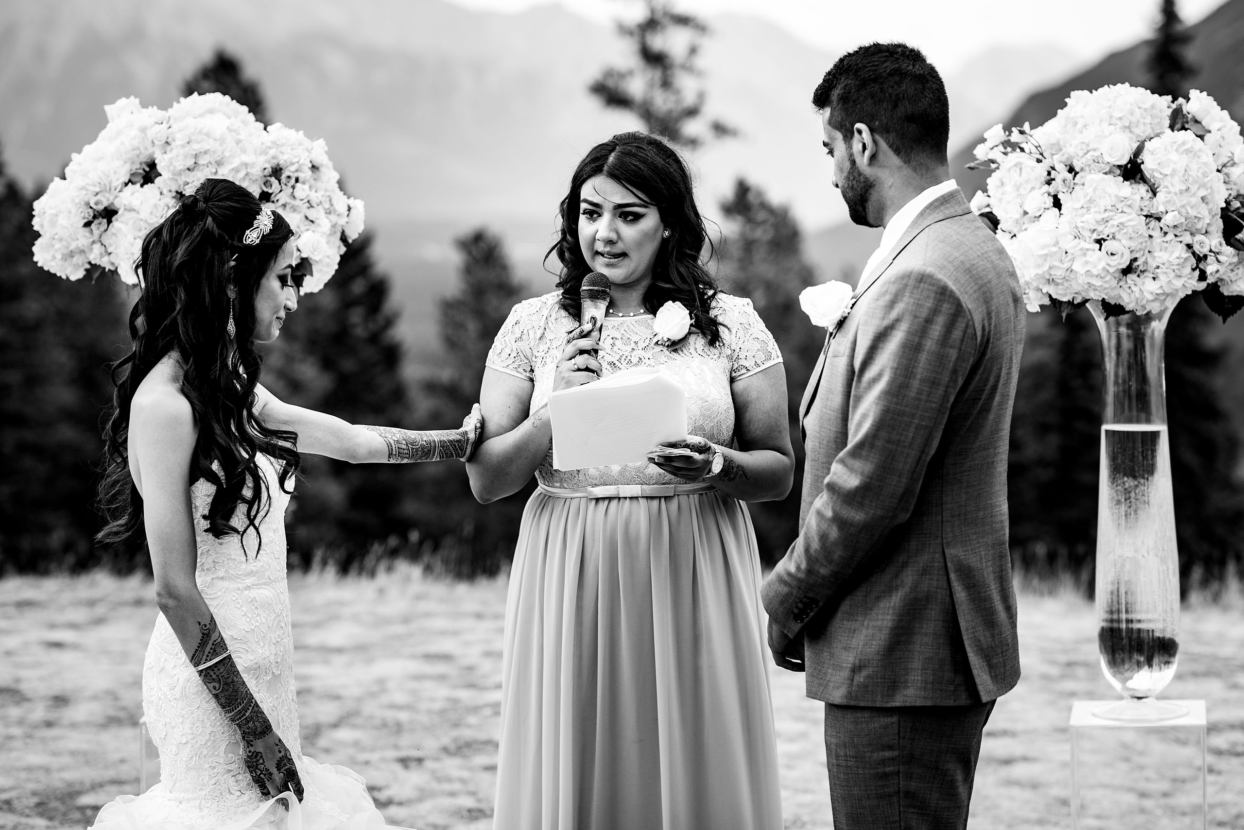 an Indian women speaking to a bride and groom by Calgary Banff Wedding Photographer Sean LeBlanc