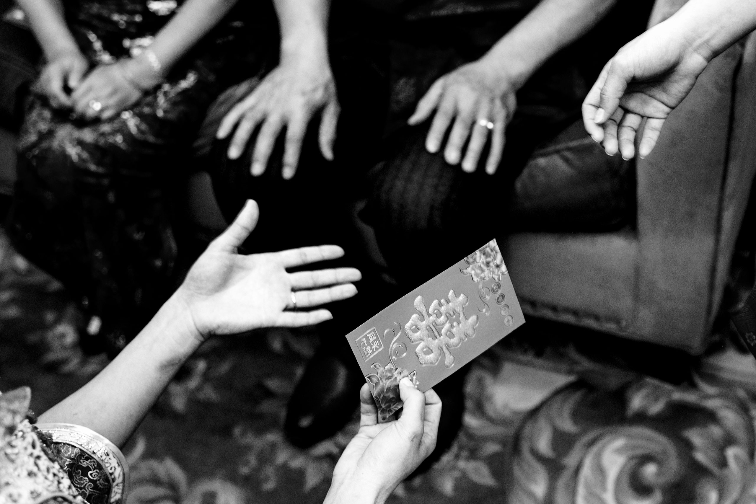 hands exchanging a gift at a calgary lake house wedding by calgary wedding photographer sean leblanc photography