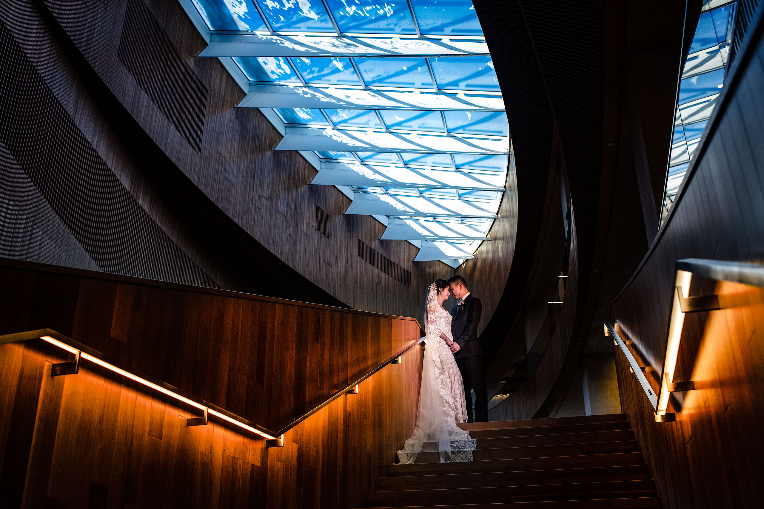 a creative bride and groom portrait at the calgary library for their calgary lake house wedding by calgary wedding photographer sean leblanc photography