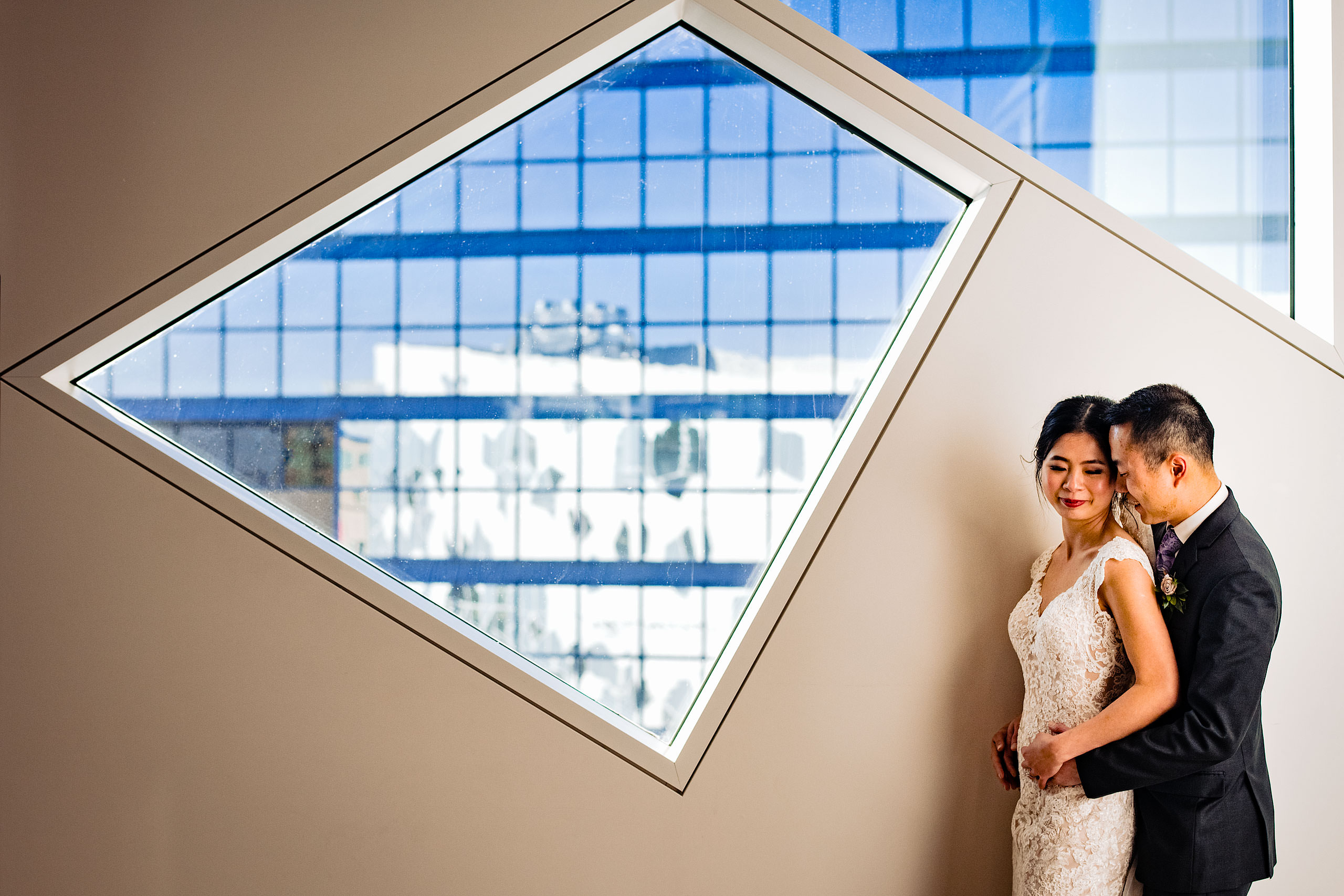 a creative bride and groom portrait at the calgary library for their calgary lake house wedding by calgary wedding photographer sean leblanc photography