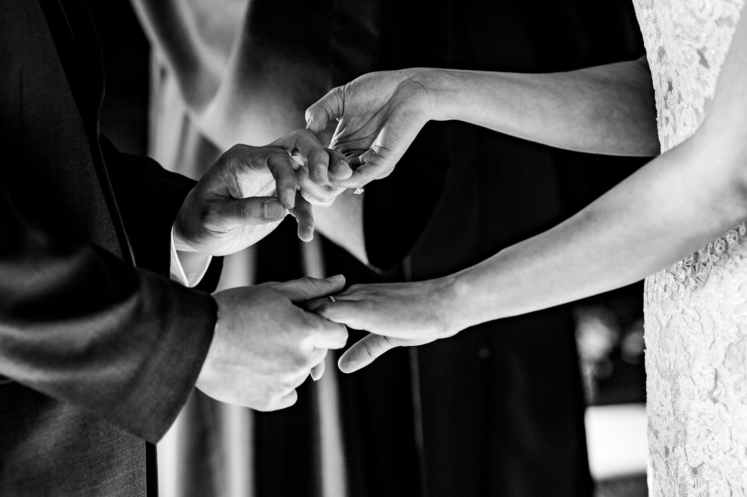 a bride and groom holding hands at their calgary lake house wedding by calgary wedding photographer sean leblanc photography