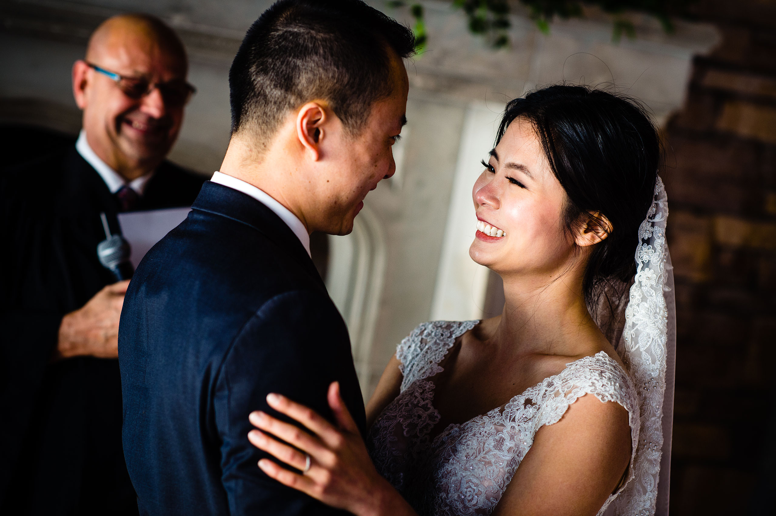 a bride and groom smiling at each other at their calgary lake house wedding by calgary wedding photographer sean leblanc photography