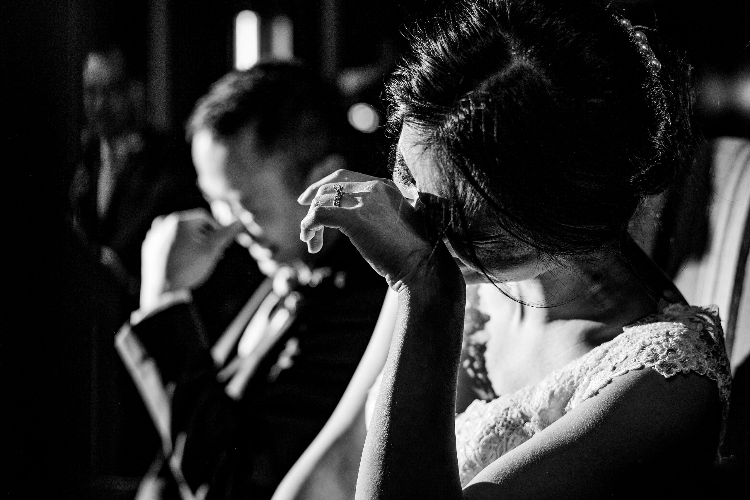 a bride and groom laughing during their reception at their calgary lake house wedding by calgary wedding photographer sean leblanc photography