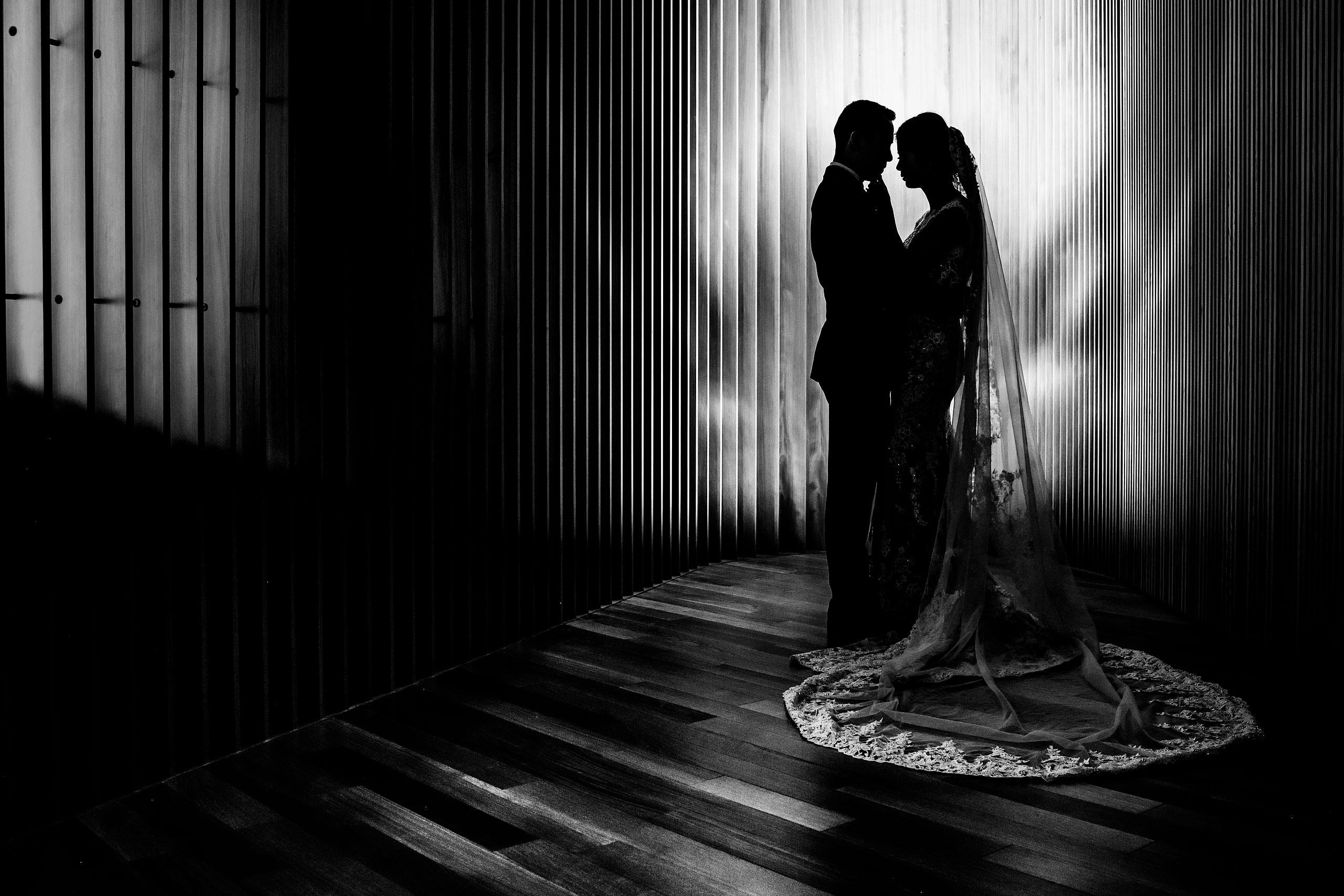 a creative bride and groom portrait at the calgary library for their calgary lake house wedding by calgary wedding photographer sean leblanc photography