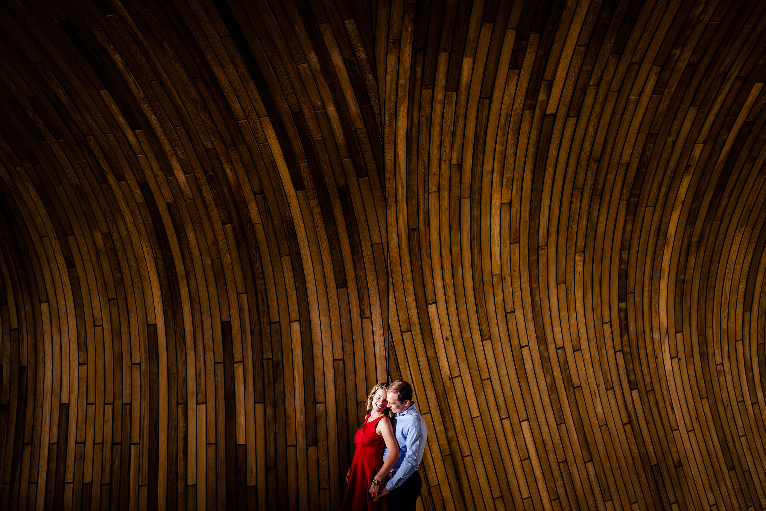 engaged couple in front of the new calgary library by engagement photographer sean leblanc