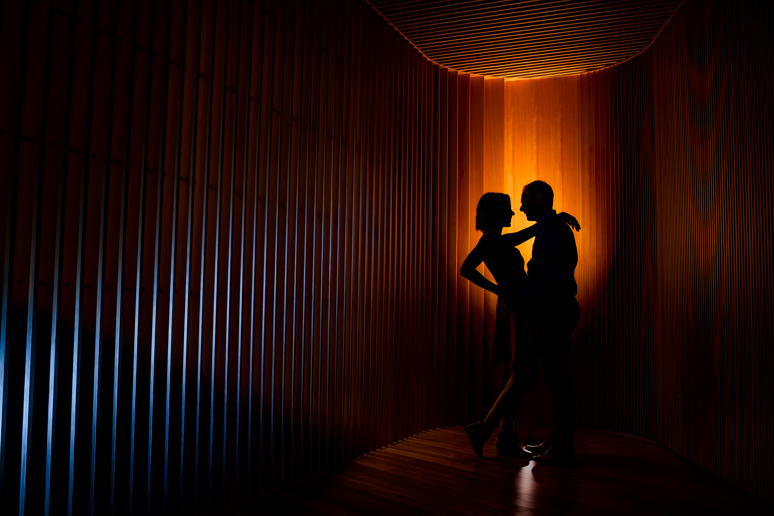 engaged couple in front of the new calgary library by engagement photographer sean leblanc