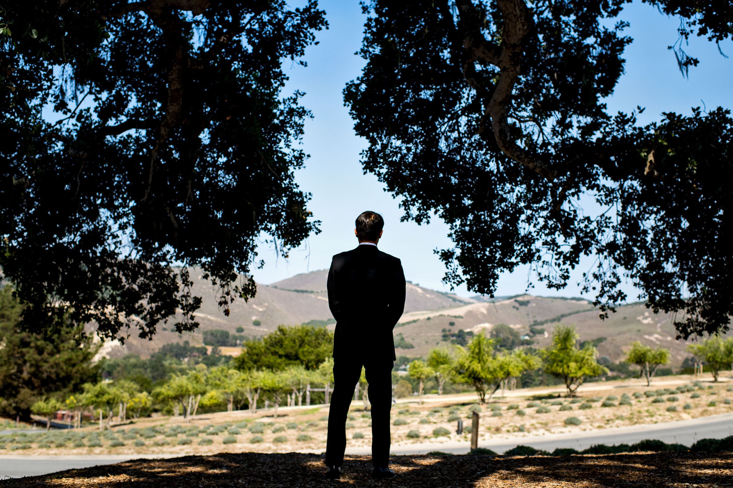 Groom standing by Carmel Valley Ranch Wedding Photographer Sean LeBlanc