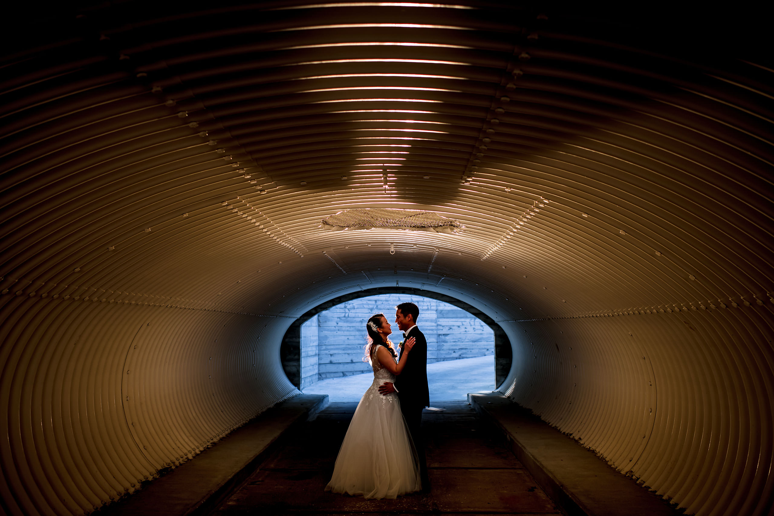 Bride and groom in a golf cart tunnel by Carmel Valley Ranch Wedding Photographer Sean LeBlanc