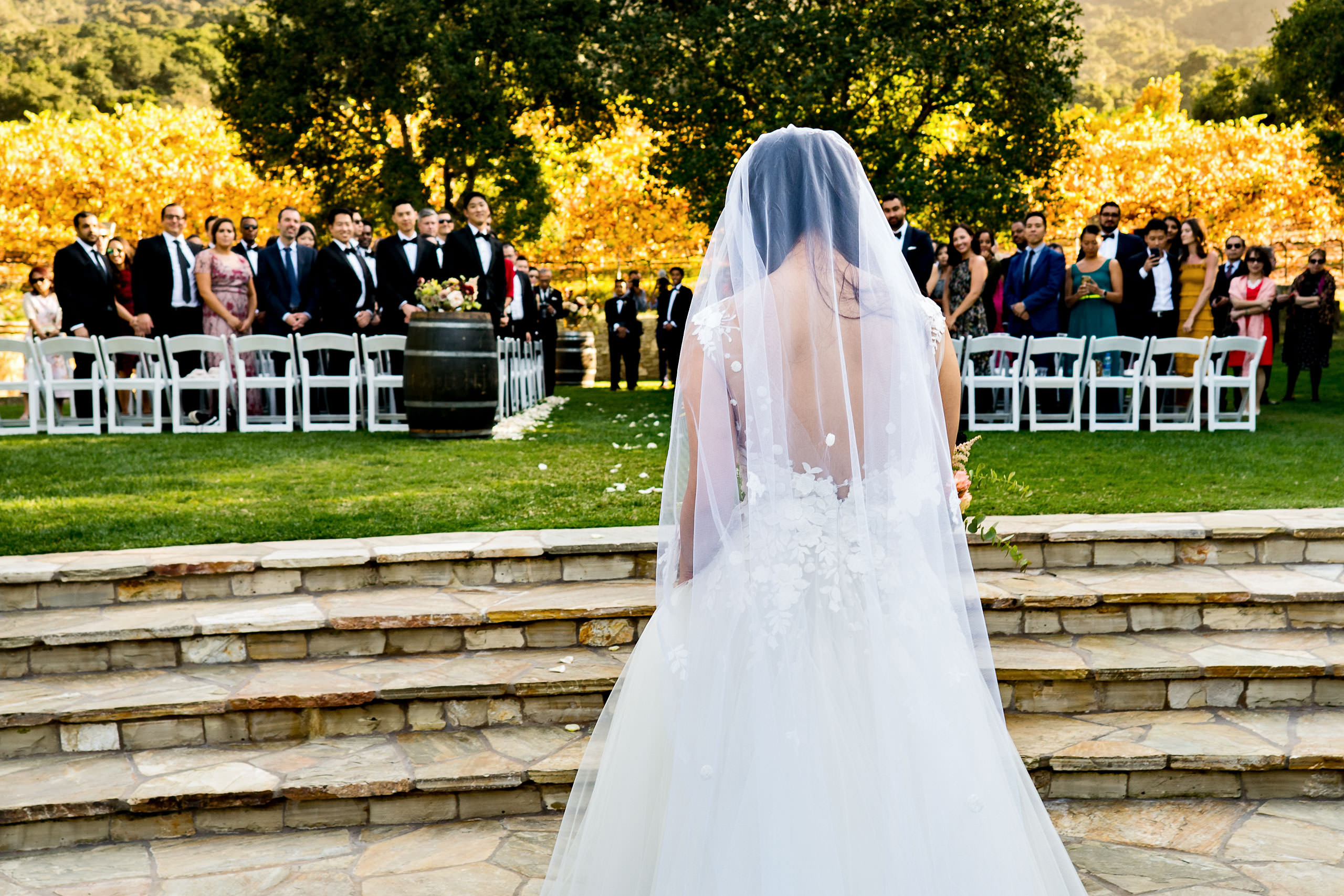 Bride walking down the aisle by Carmel Valley Ranch Wedding Photographer Sean LeBlanc