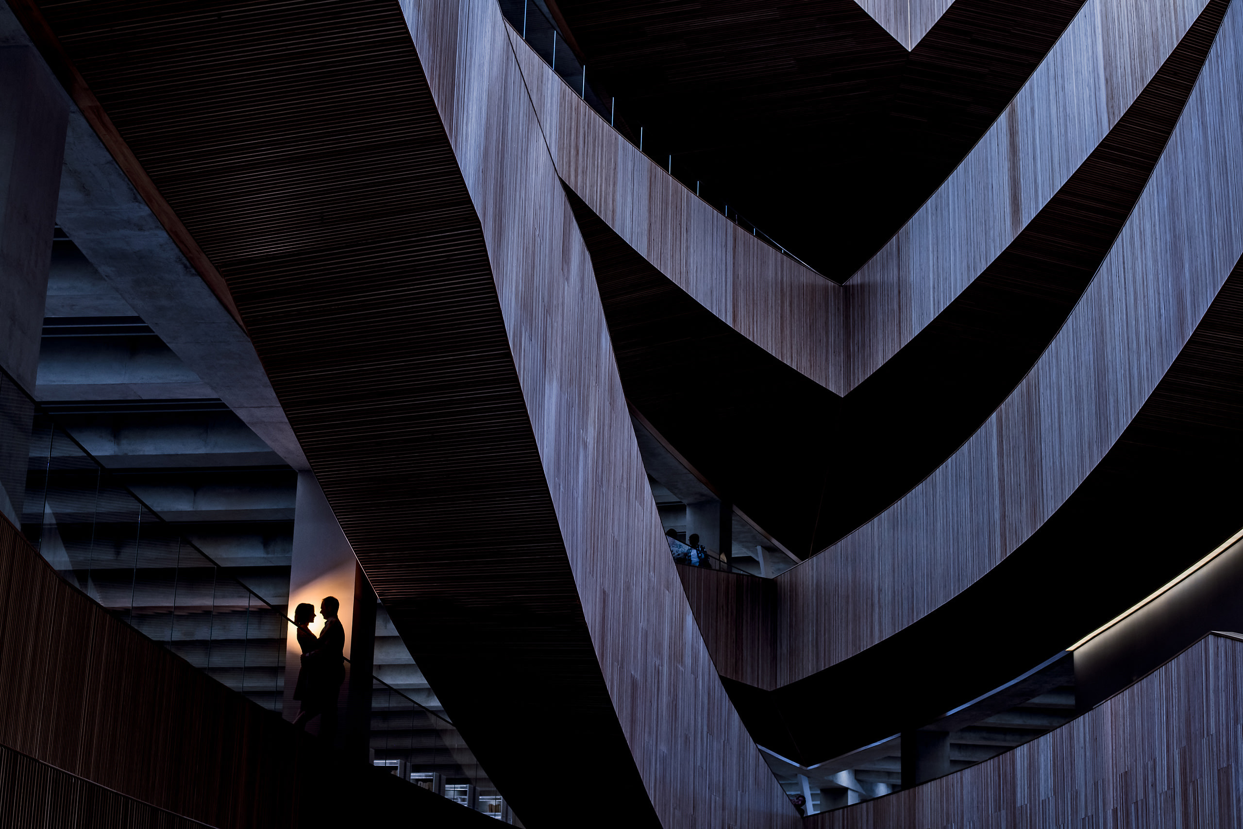 A couple silhouetted at the calgary public library by engagement photographer Sean LeBlanc